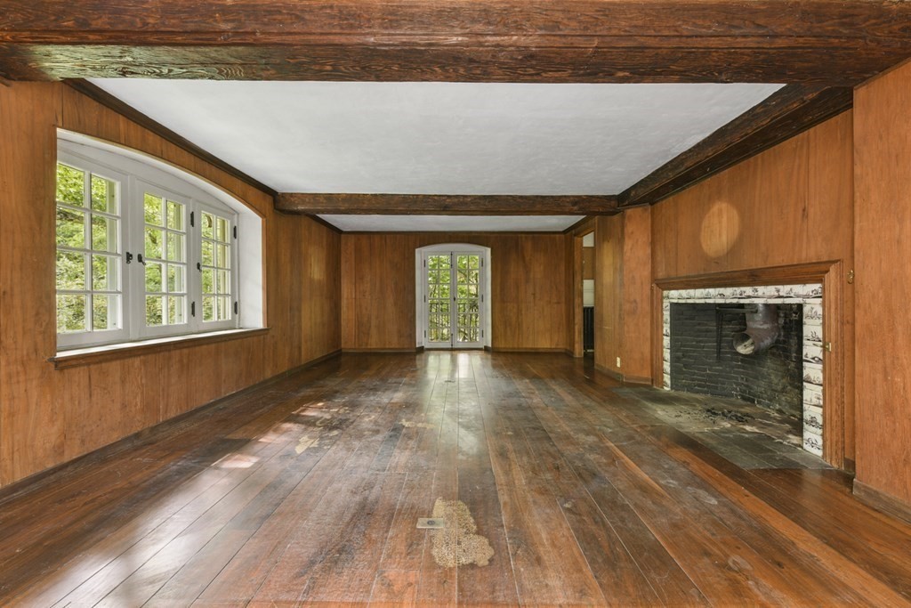 25 Plympton Road Sudbury, MA 01776 - Photo 14 of 19 a view of an empty room with a fireplace and a window