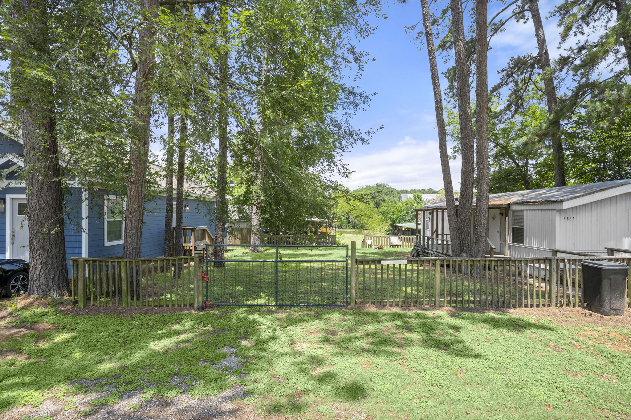 9649 Warm Spring Willis, TX 77318 - Photo 6 of 30 A well-maintained fenced yard offers privacy and a secure outdoor space.
