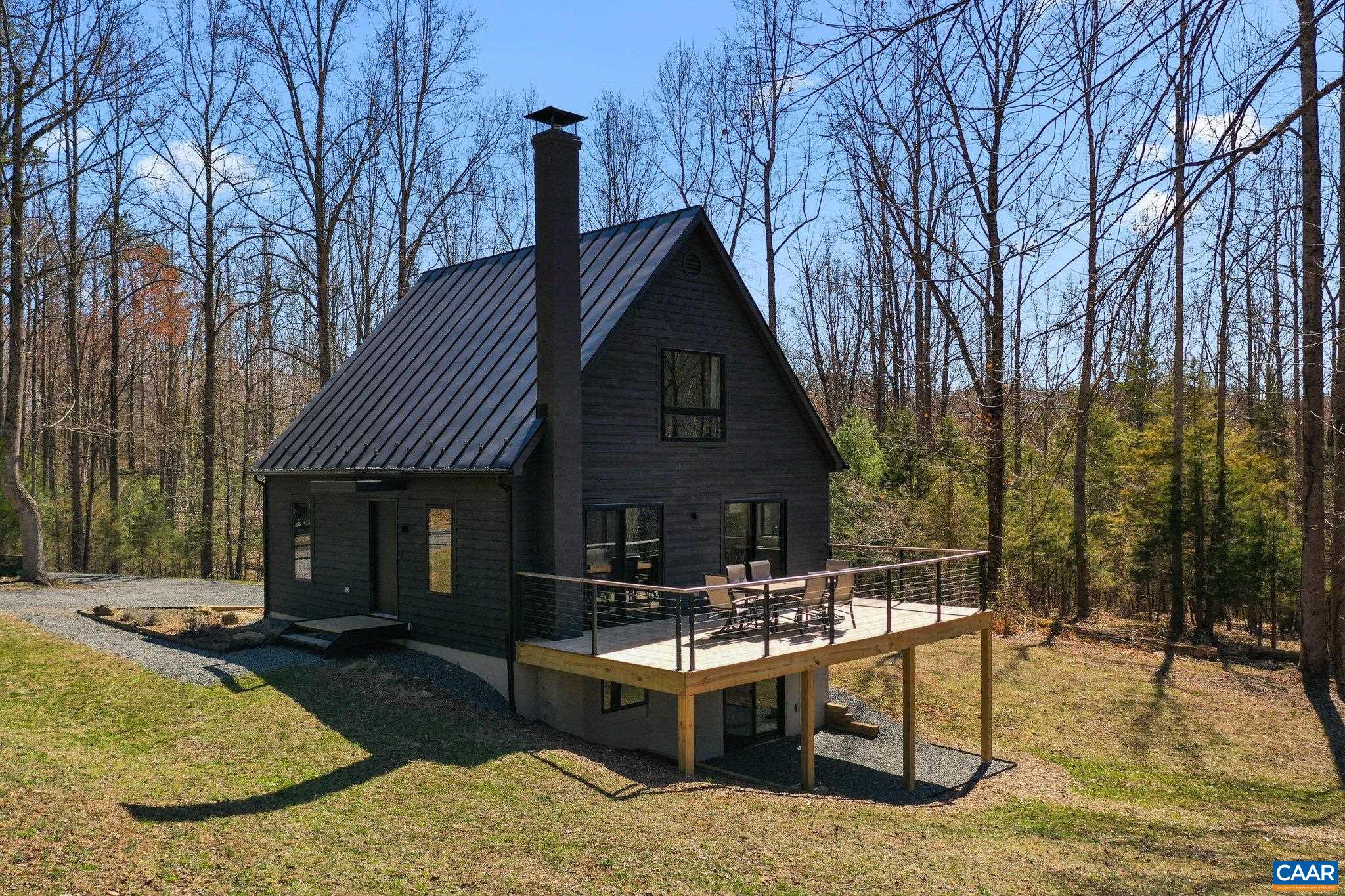 6500 Free Union Road Free Union, VA 22940 - Photo 1 of 35 a view of backyard with table and chairs a fire pit and large trees