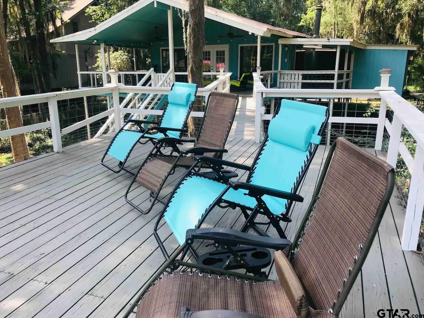 230 Sesame Street West Karnack, TX 75661 - Photo 15 of 44 a view of a chairs and table on the wooden deck