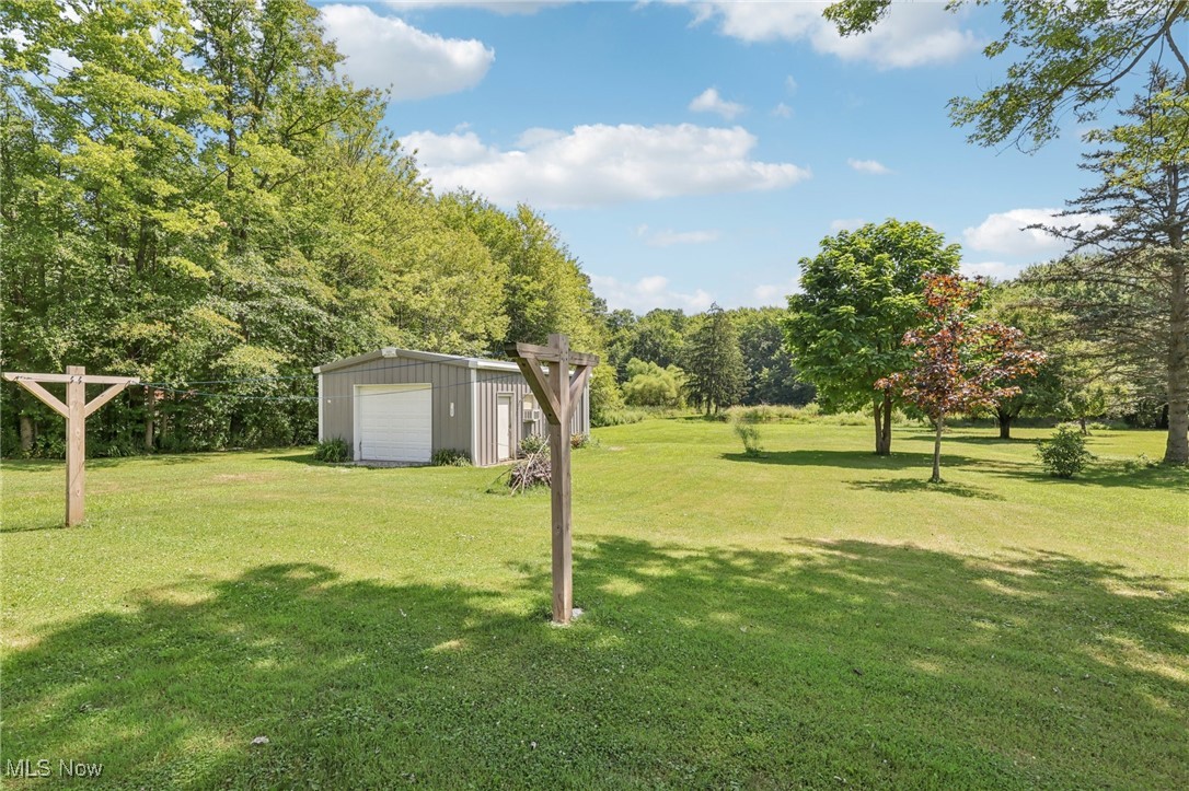 5097 Chillicothe Road Chagrin Falls, OH 44022 - Photo 38 of 45 View of grassy yard featuring an outdoor structure and a garage