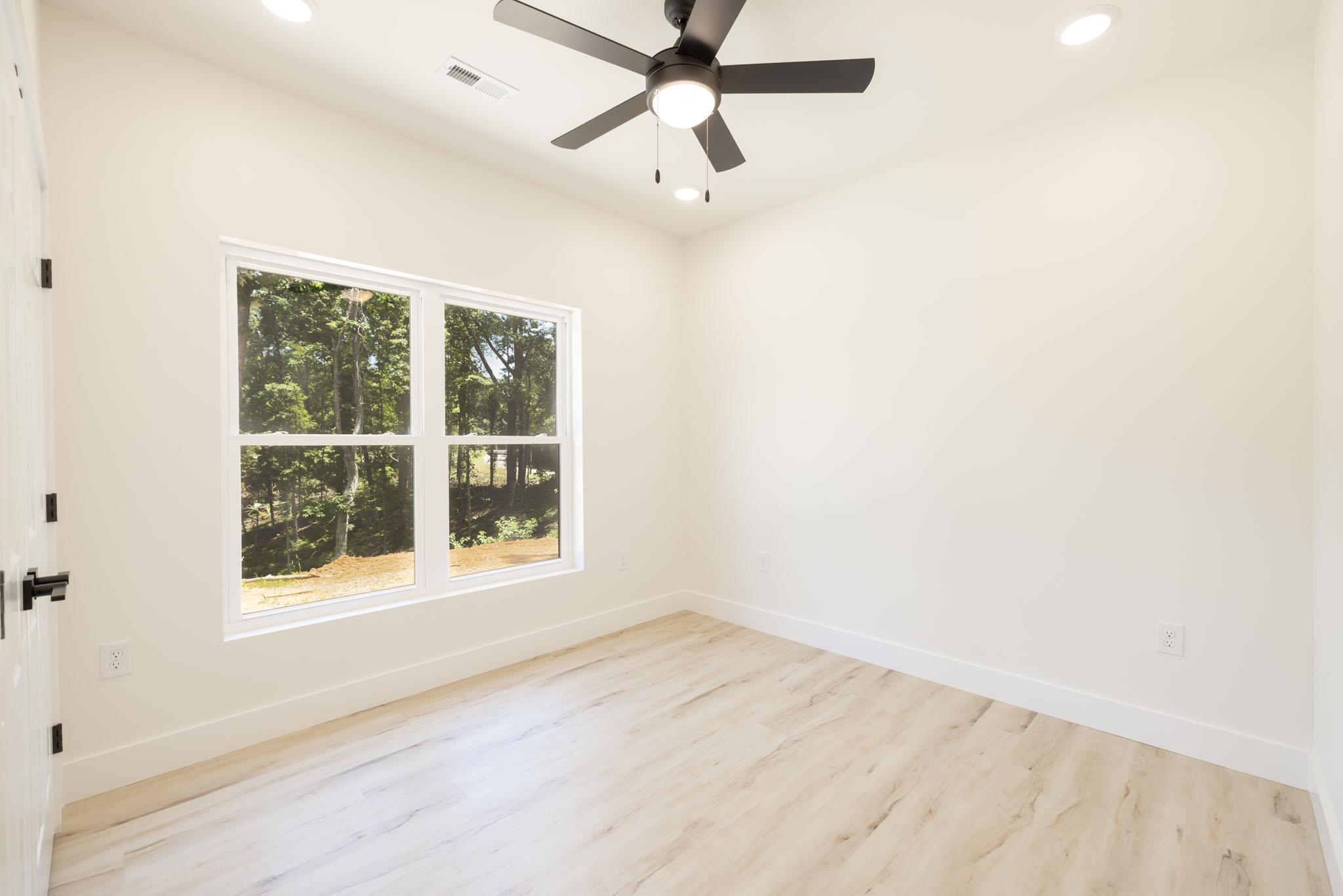 37 William Teague Lane Ramer, TN 38367 - Photo 36 of 39 Neutral wall color complemented by wood-finish flooring