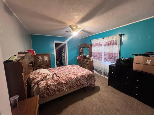 a bedroom with a bed and dresser with mirror