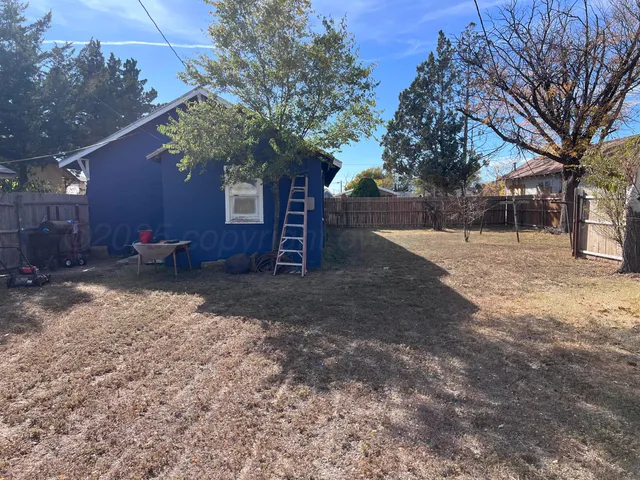 a backyard of a house with lots of green space and outdoor seating