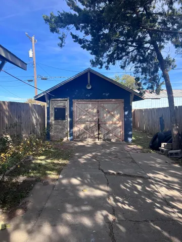 a wooden house with trees in front of it