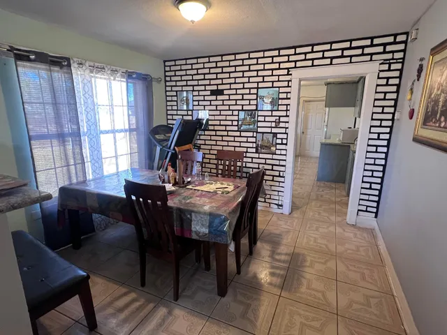 a view of a dining room with furniture and window