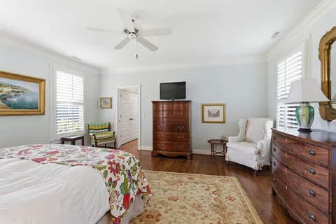 a bedroom with a bed dresser and a window