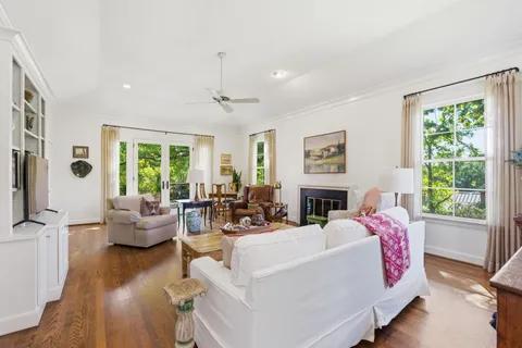 a living room with fireplace furniture and a large window