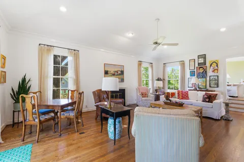 a living room with furniture and wooden floor