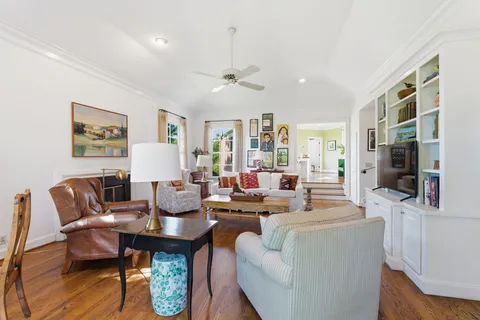 a living room with fireplace furniture and a large window