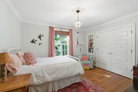 a bedroom with a bed and a chandelier
