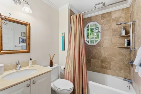 a bathroom with a granite countertop toilet a sink and a mirror