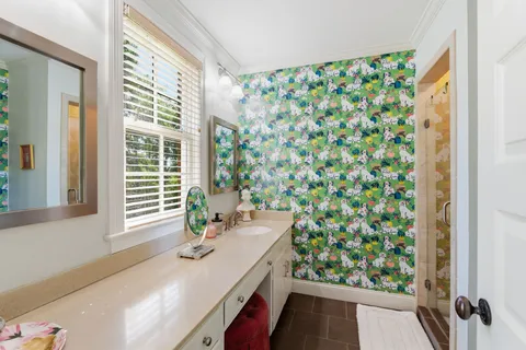 a bath room with a sink and a mirror
