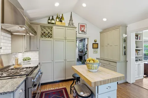 a kitchen with a sink stove and refrigerator
