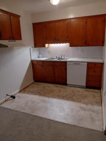 a room with granite countertop cabinets and a sink