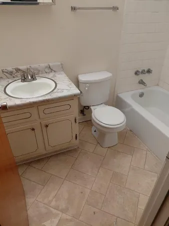 a bathroom with a sink a toilet and bathtub