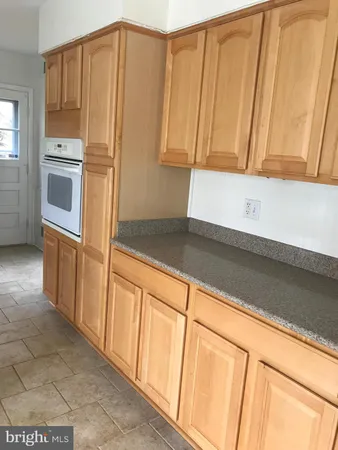 a kitchen with stainless steel appliances a refrigerator and a microwave