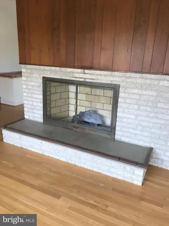 a view of a livingroom with wooden floor and a flat screen tv