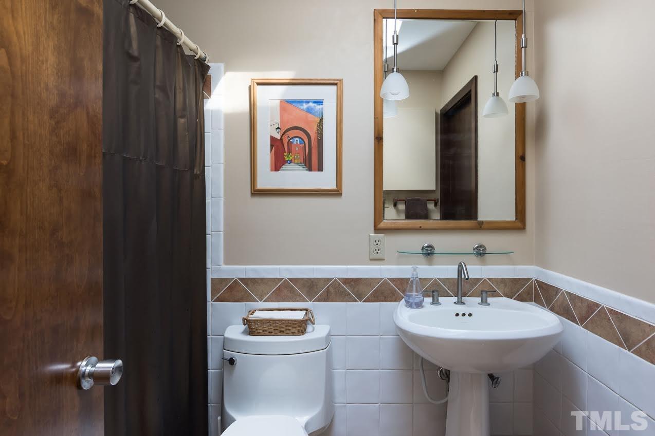 1500 Southview Road Durham, NC 27703 - Photo 12 of 22 a bathroom with a toilet sink and mirror