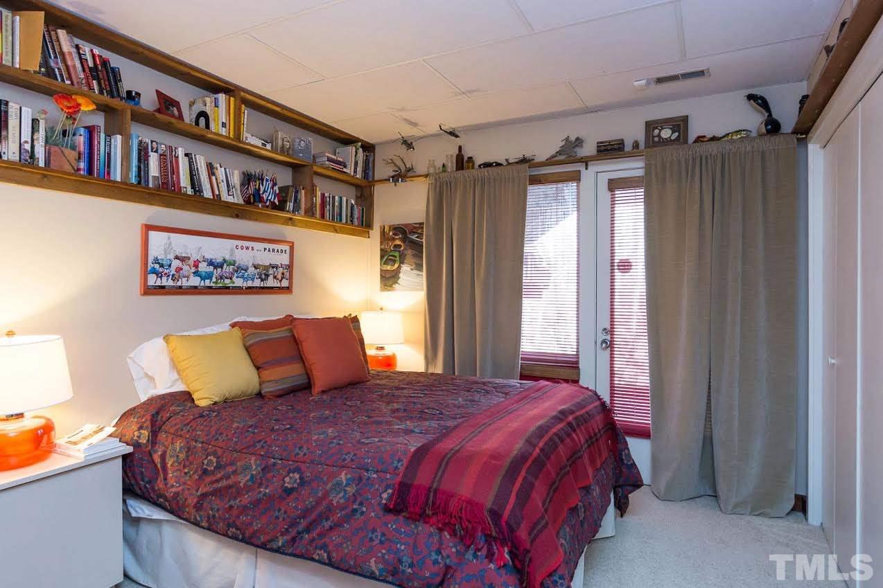 1500 Southview Road Durham, NC 27703 - Photo 17 of 22 a bed sitting in a bedroom next to a book shelf