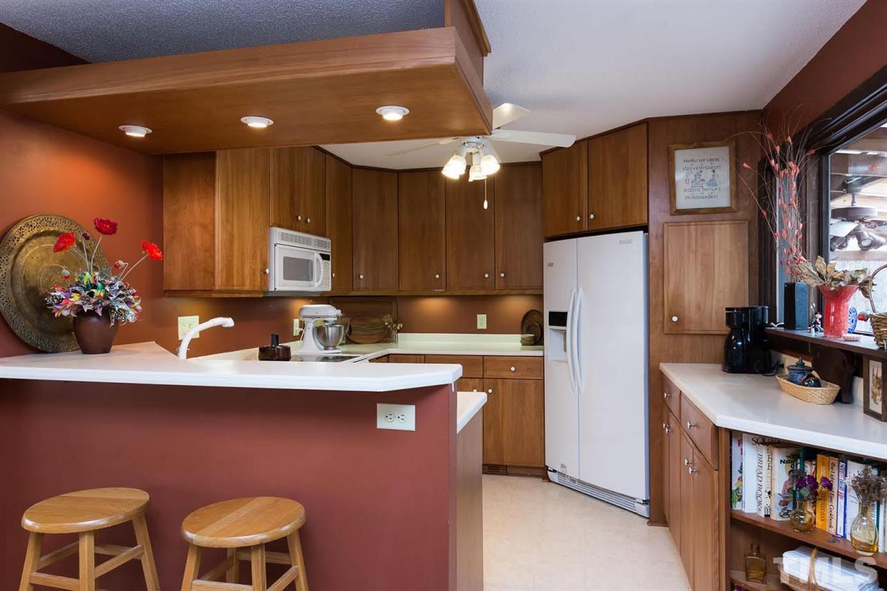 1500 Southview Road Durham, NC 27703 - Photo 7 of 22 a kitchen with stainless steel appliances a sink cabinets and wooden floor