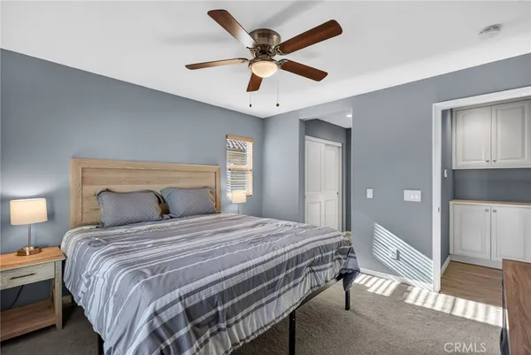 a bedroom with a bed and a chandelier