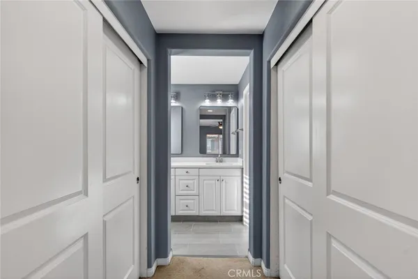 a bathroom with double sink and a mirror