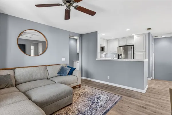 a living room with furniture and a wooden floor