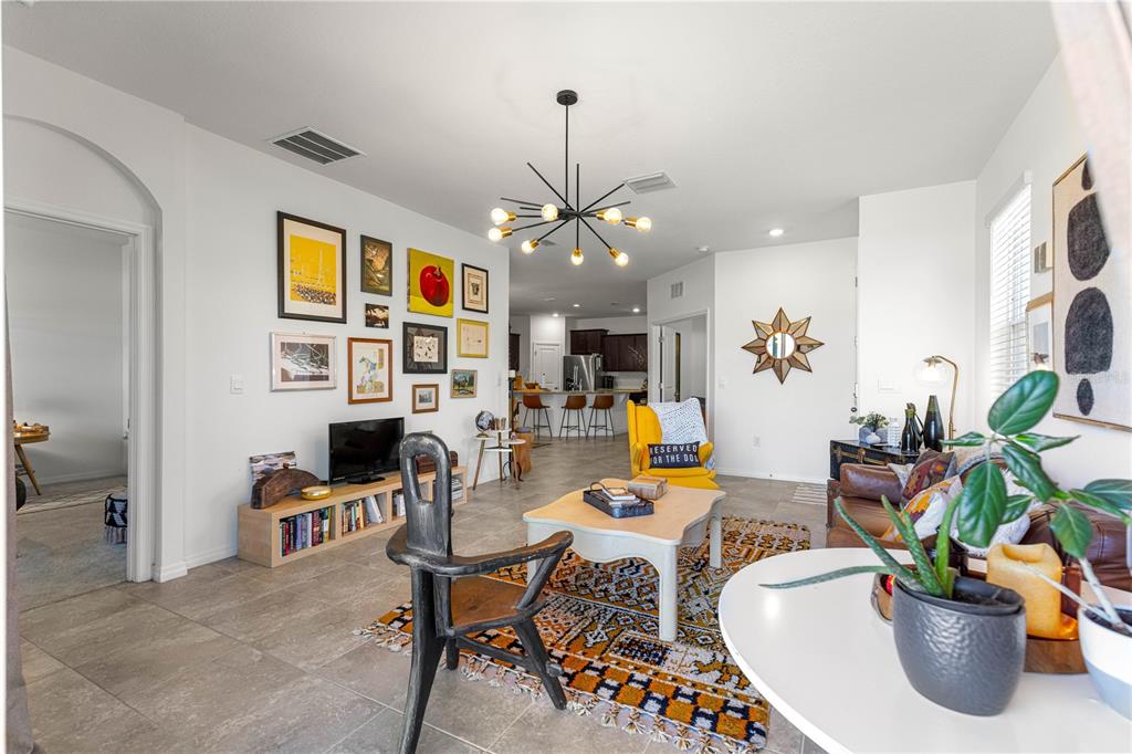 5377 Northwest 46th Lane Road Ocala, FL 34482 - Photo 12 of 59 a view of a dining room with furniture a rug and a chandelier