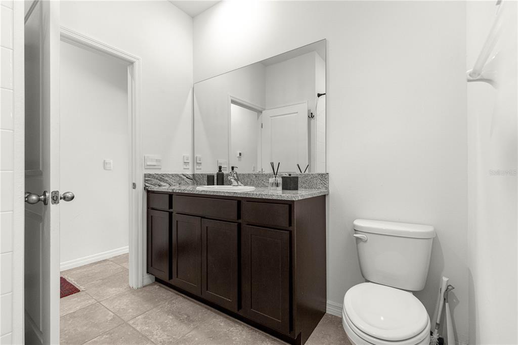 5377 Northwest 46th Lane Road Ocala, FL 34482 - Photo 34 of 59 a bathroom with a toilet a sink and mirror