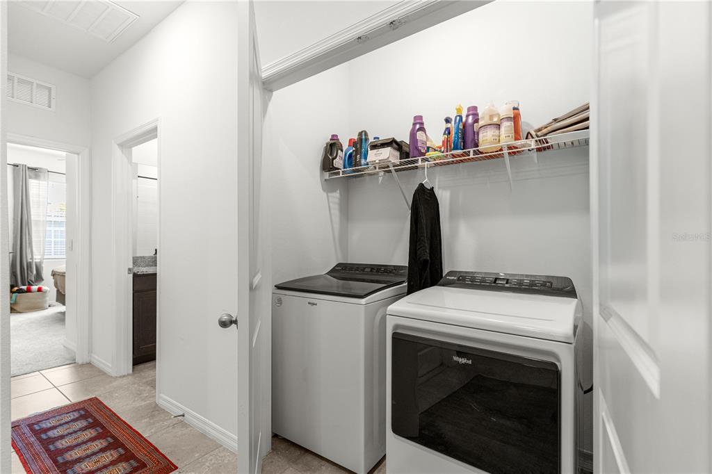 5377 Northwest 46th Lane Road Ocala, FL 34482 - Photo 39 of 59 a view of washer and dryer with kitchen in the background