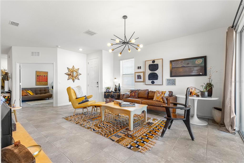 5377 Northwest 46th Lane Road Ocala, FL 34482 - Photo 9 of 59 a living room with furniture a chandelier and a rug