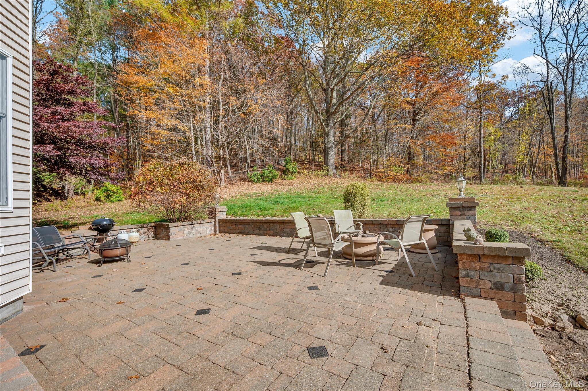 424 Gage Road Brewster, NY 10509 - Photo 35 of 42 a view of a patio with a table and chairs under an umbrella