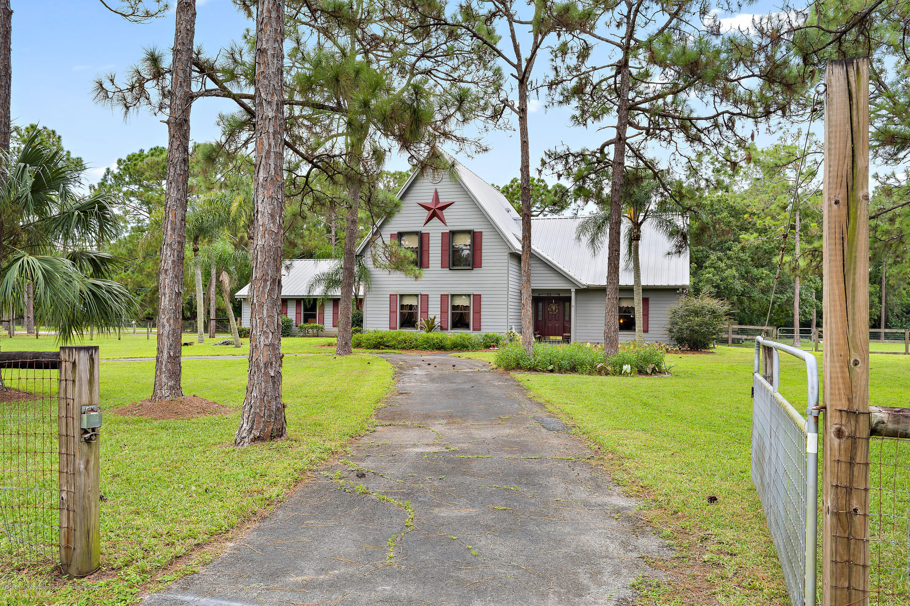 12142 157th Street North Jupiter, FL 33478 - Photo 13 of 49 a front view of a house with a yard and porch