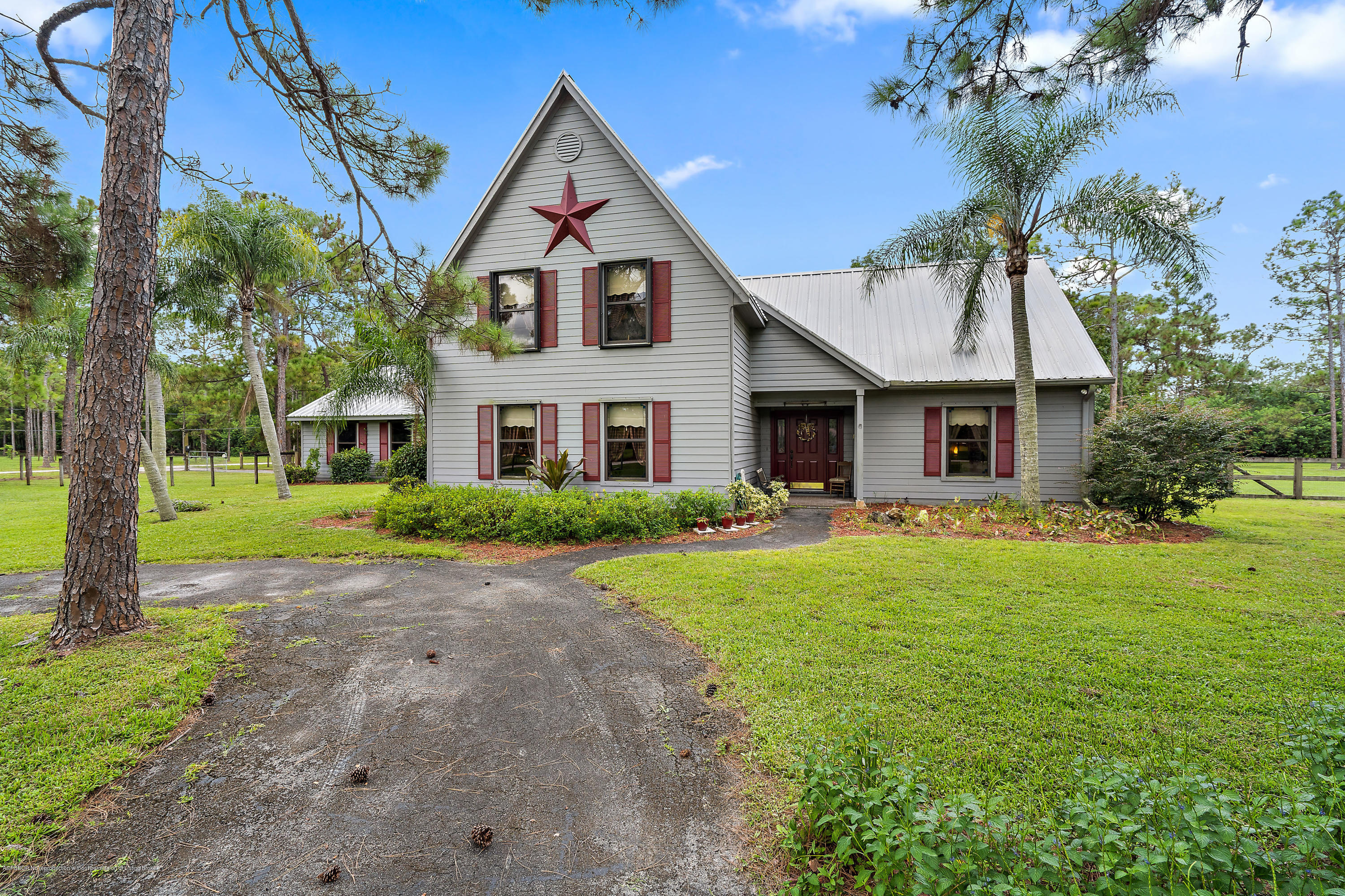 12142 157th Street North Jupiter, FL 33478 - Photo 14 of 49 a front view of a house with a yard