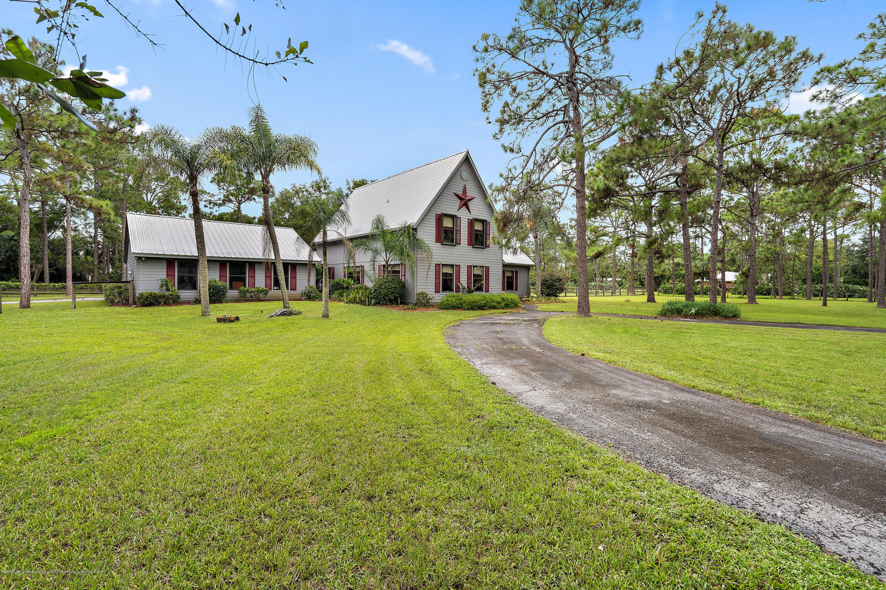 12142 157th Street North Jupiter, FL 33478 - Photo 15 of 49 a view of a house with a big yard and large trees