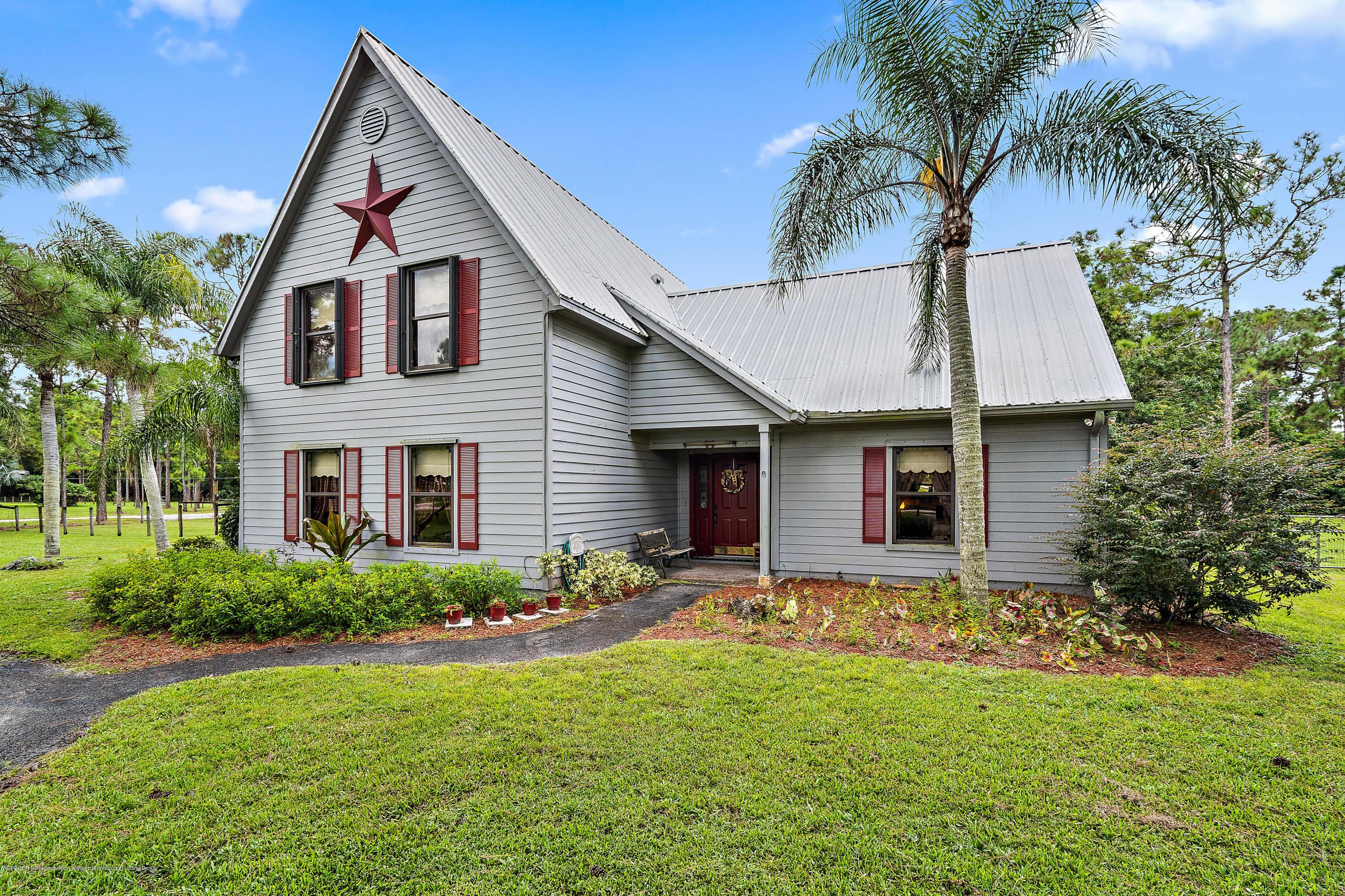 12142 157th Street North Jupiter, FL 33478 - Photo 16 of 49 a front view of house with yard and green space