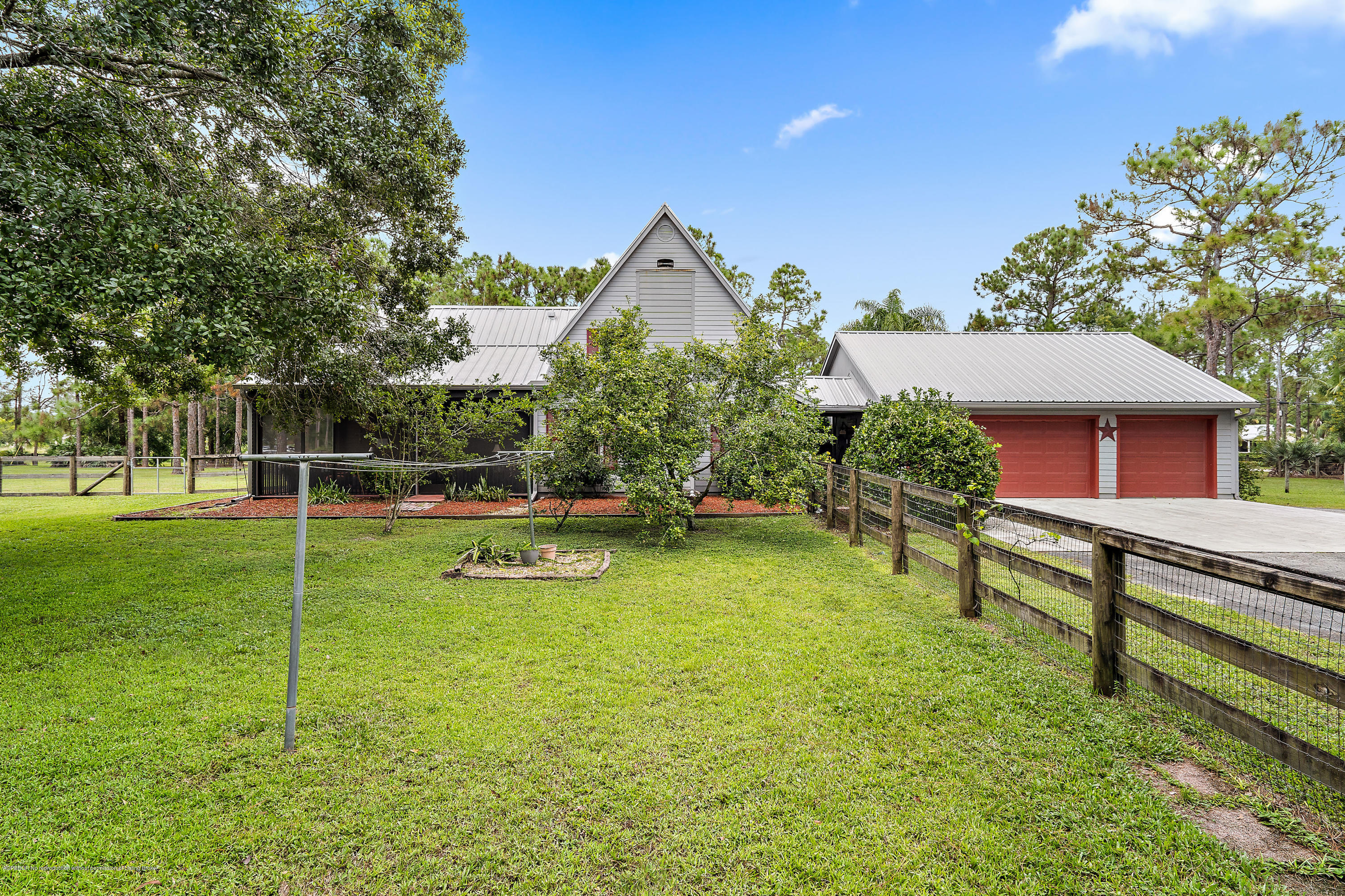 12142 157th Street North Jupiter, FL 33478 - Photo 20 of 49 a house view with a sitting space and garden