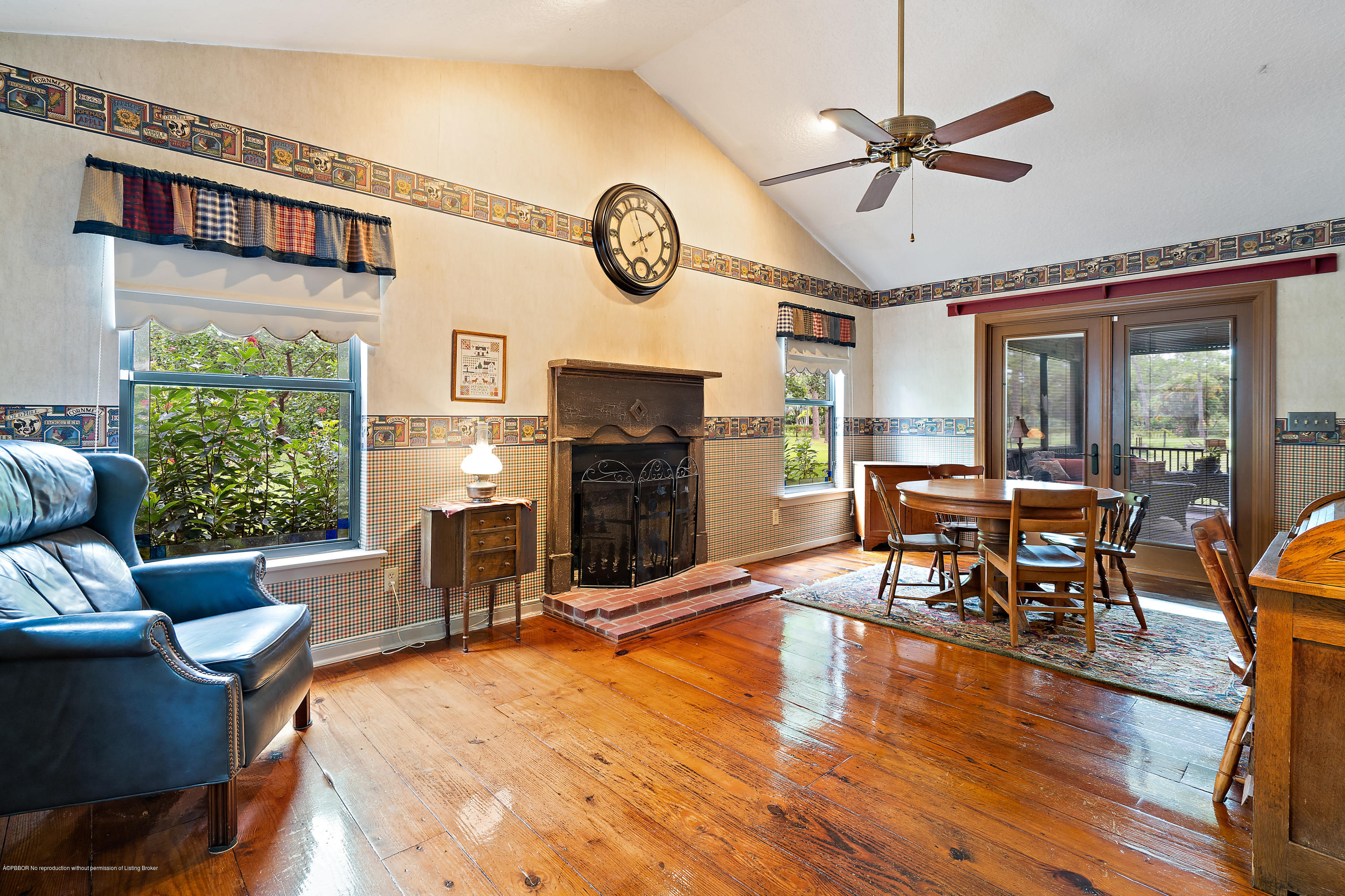 12142 157th Street North Jupiter, FL 33478 - Photo 25 of 49 a living room with furniture a fireplace and a large window