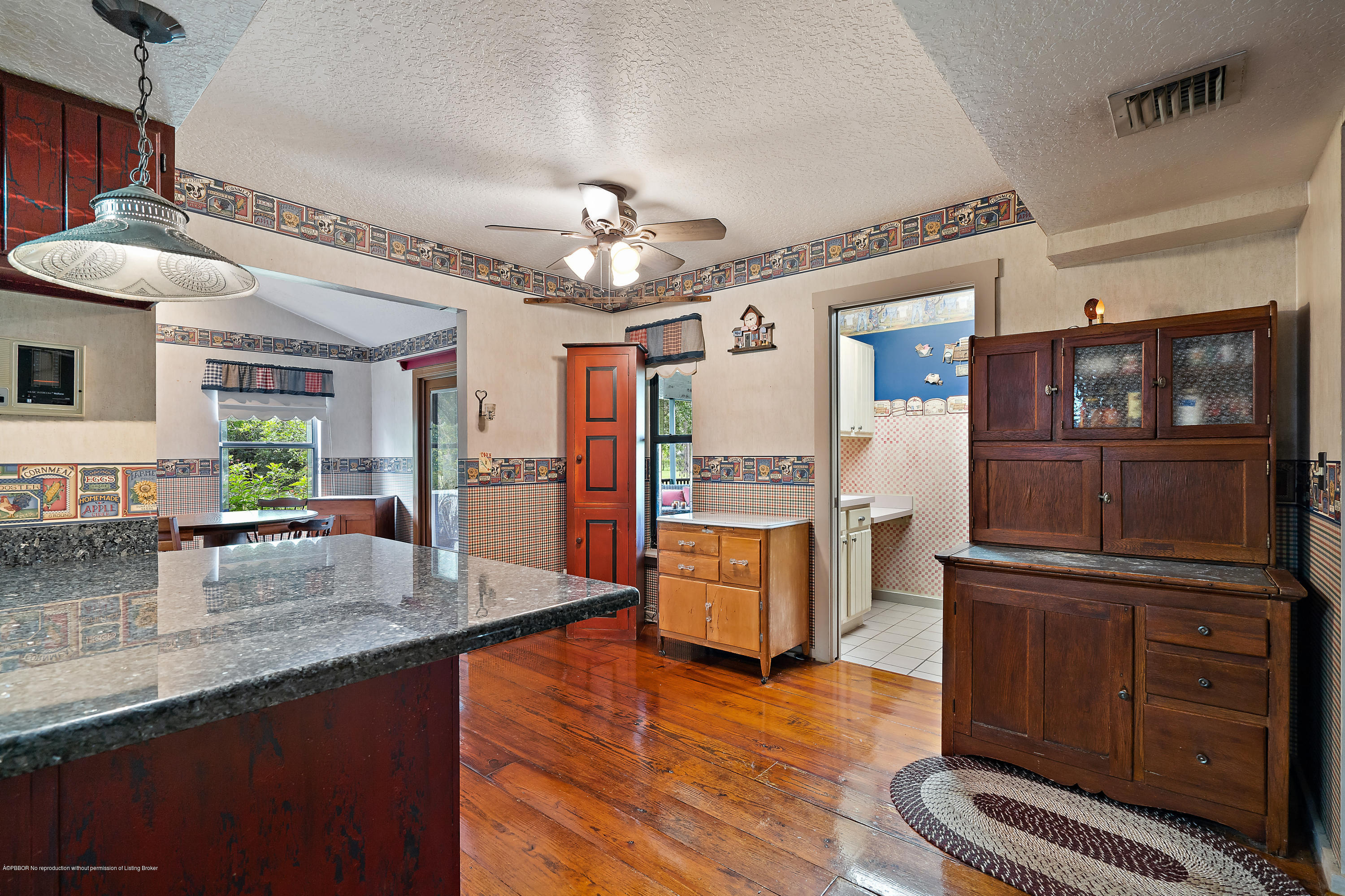 12142 157th Street North Jupiter, FL 33478 - Photo 26 of 49 a kitchen with stainless steel appliances granite countertop a refrigerator a stove and a sink with cabinets