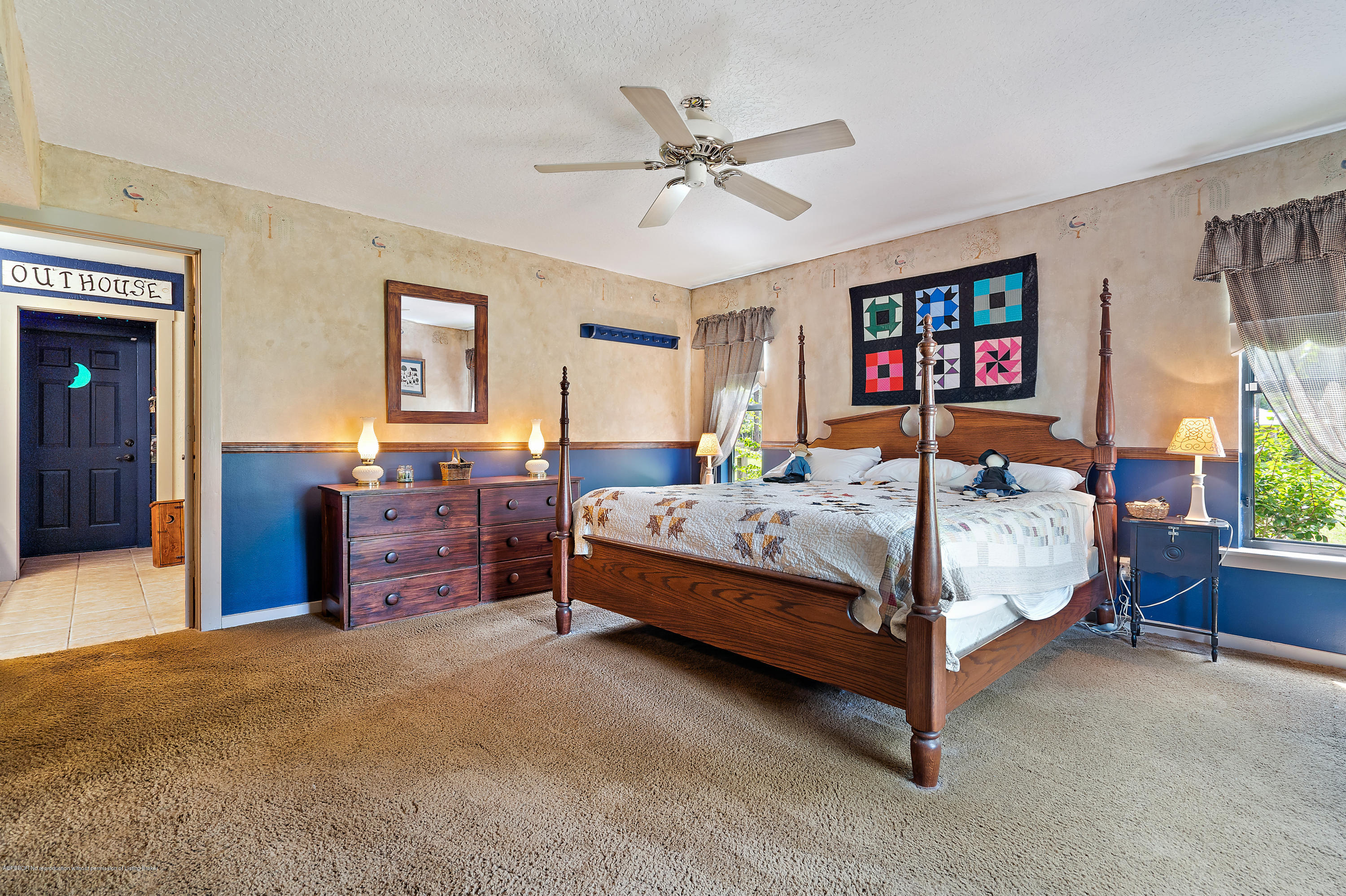12142 157th Street North Jupiter, FL 33478 - Photo 34 of 49 a bedroom with a bed and a chandelier
