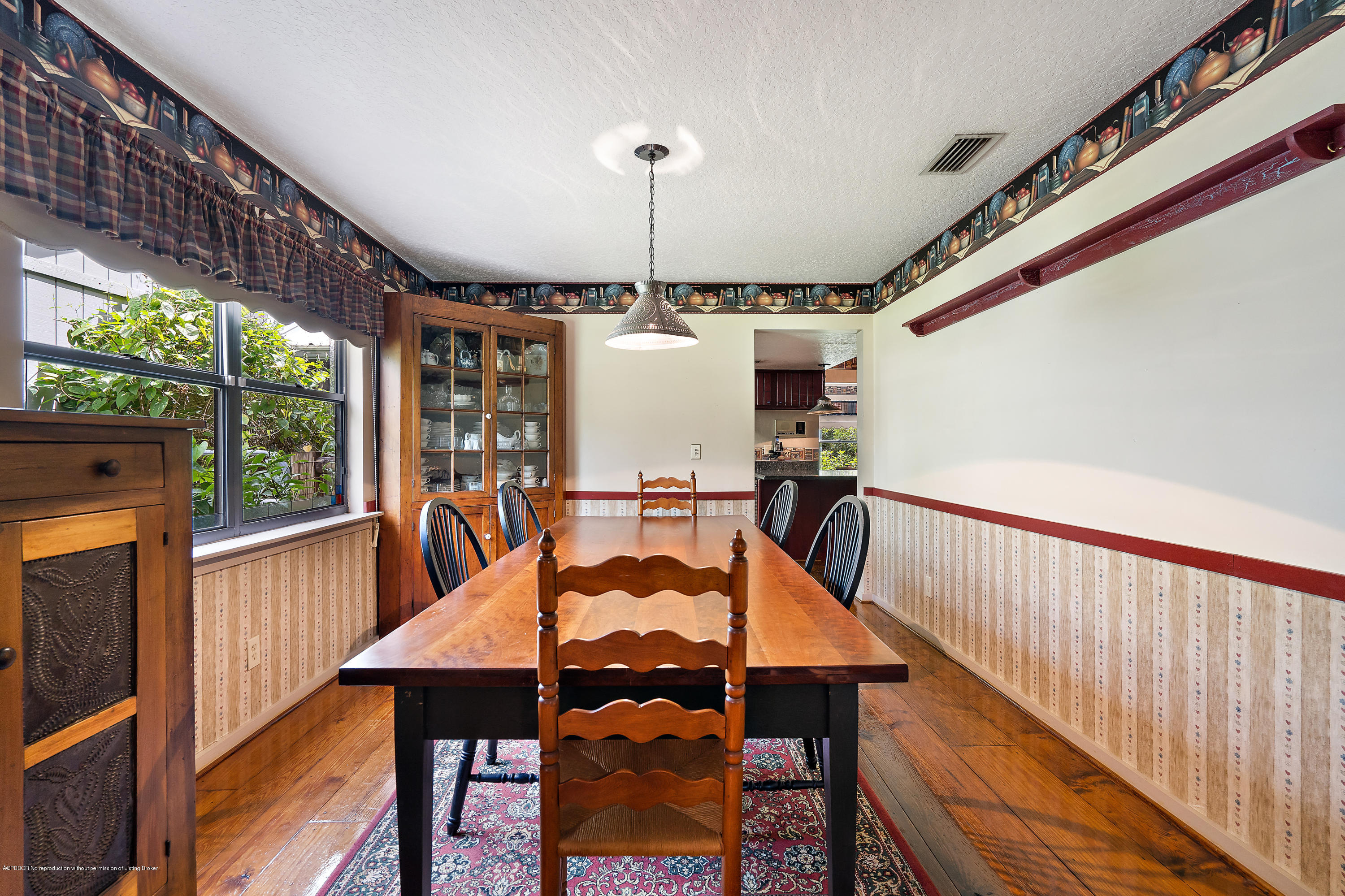 12142 157th Street North Jupiter, FL 33478 - Photo 37 of 49 a view of a dining room with furniture window and wooden floor