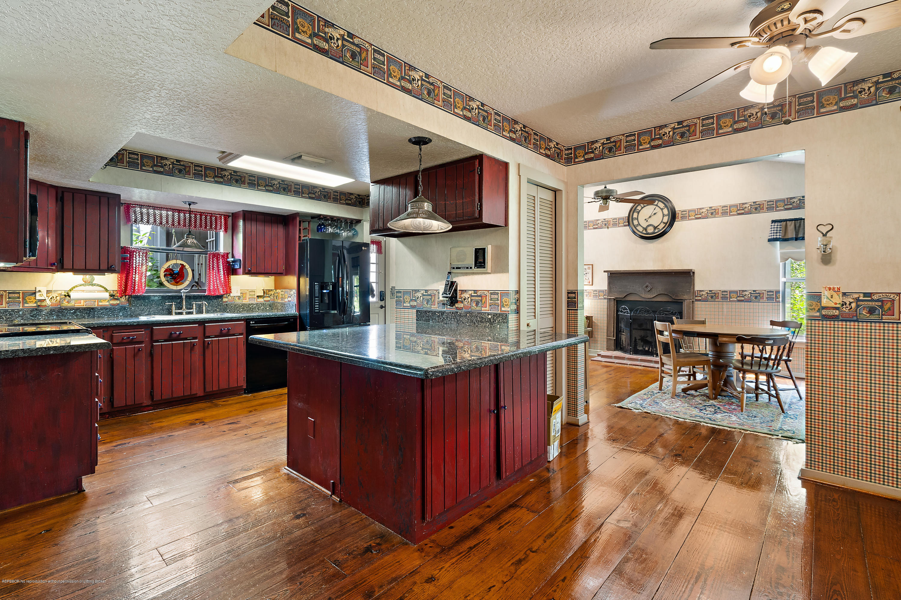 12142 157th Street North Jupiter, FL 33478 - Photo 38 of 49 a kitchen with stainless steel appliances granite countertop wooden floors and sink