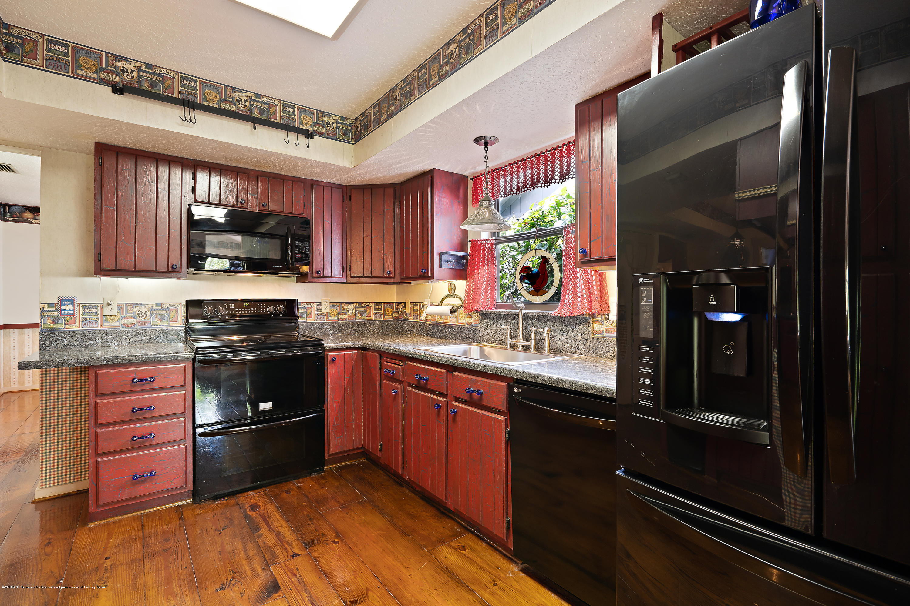 12142 157th Street North Jupiter, FL 33478 - Photo 39 of 49 a kitchen with stainless steel appliances granite countertop a stove sink and cabinets