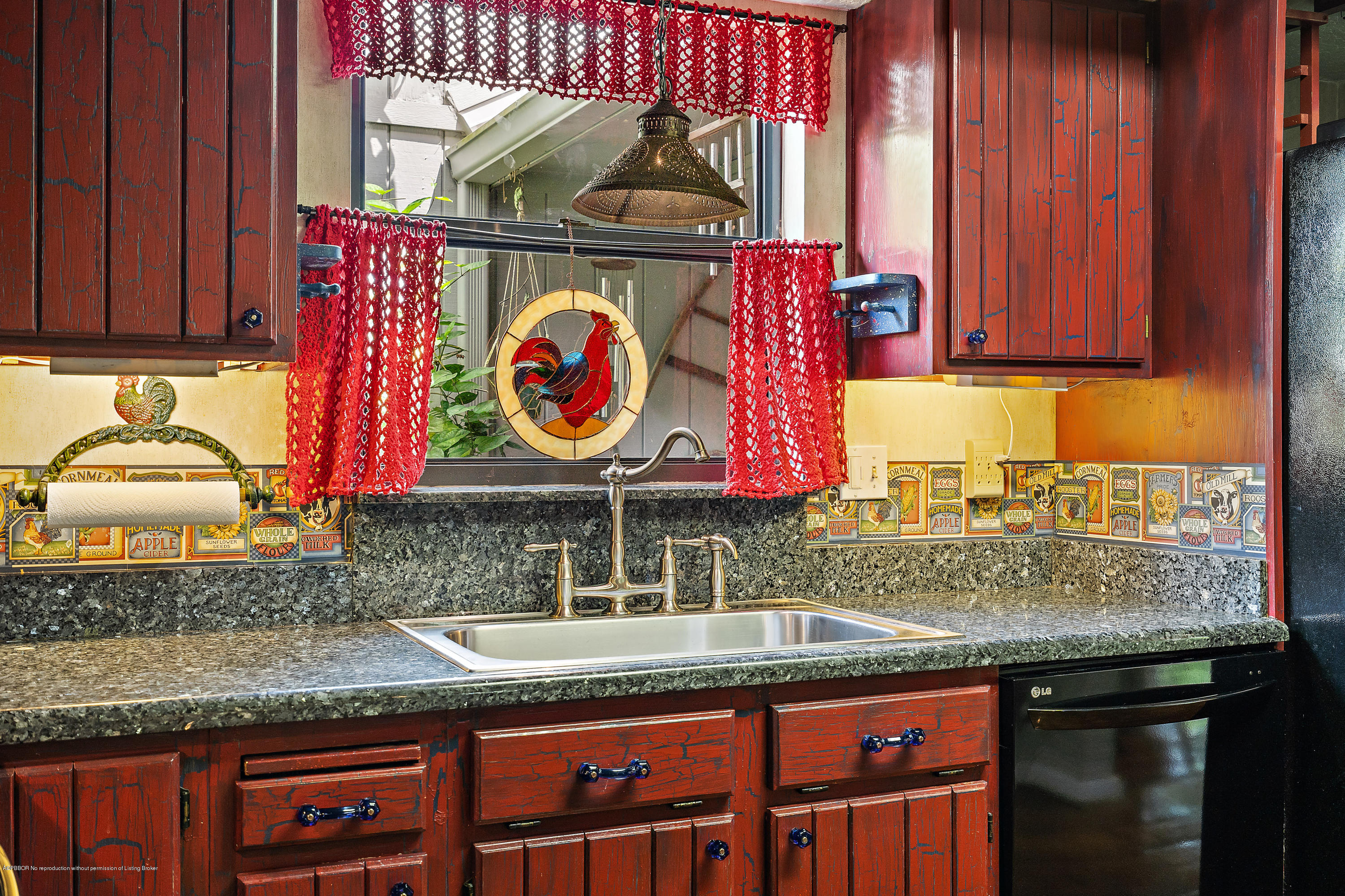 12142 157th Street North Jupiter, FL 33478 - Photo 40 of 49 a kitchen with granite countertop a sink and a stove