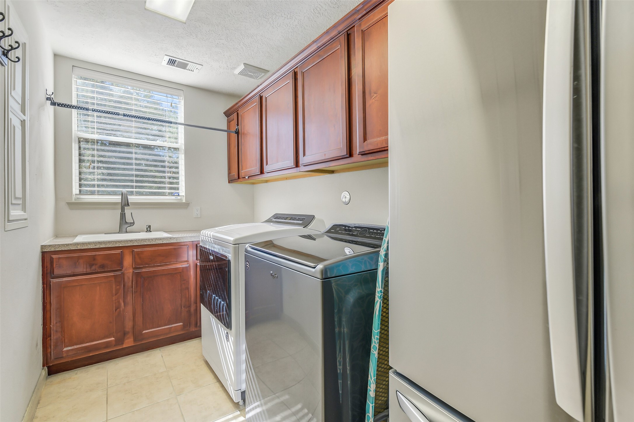 32711 Tall Oaks Way Magnolia, TX 77354 - Photo 20 of 50 a utility room with cabinets washer and dryer