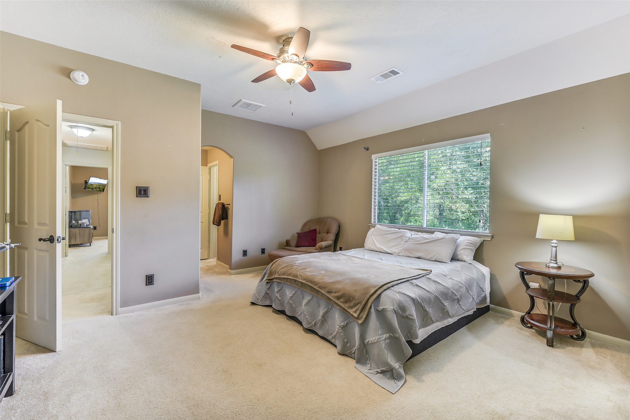 32711 Tall Oaks Way Magnolia, TX 77354 - Photo 32 of 50 a bedroom with a bed and a chandelier