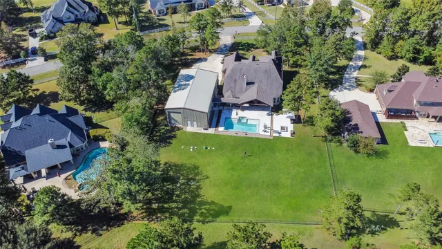 an aerial view of a house with garden space and street view
