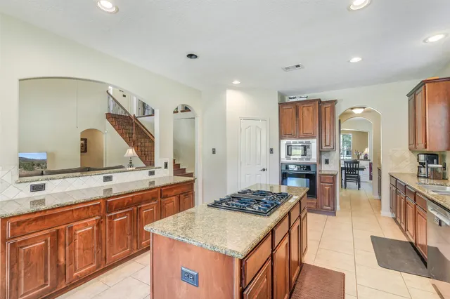 a kitchen with a sink stove and cabinets