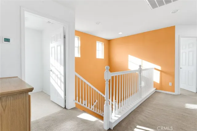 a view of a room with stairs and a window